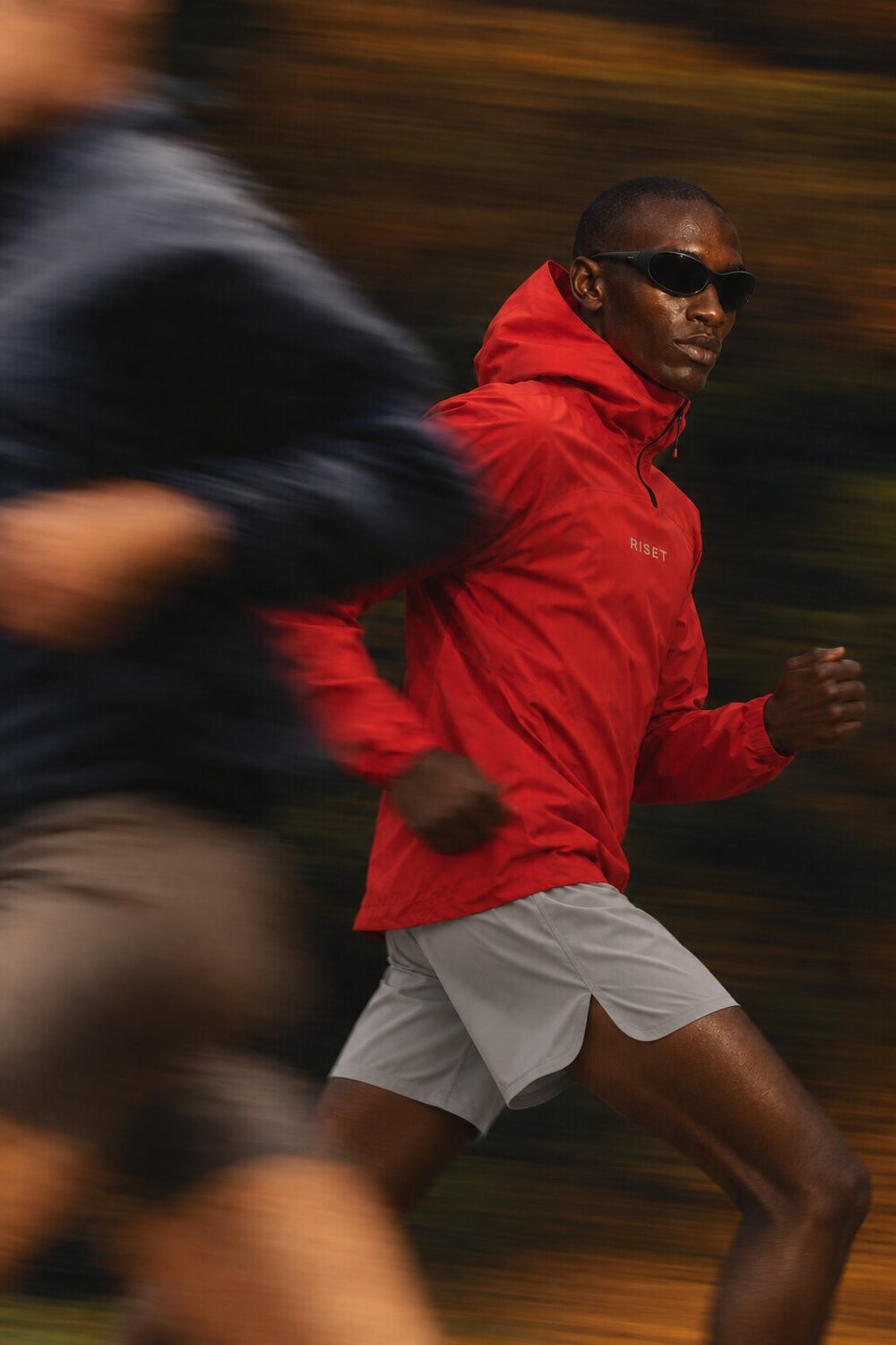 RISET SS27 campaign, red running jacket in motion